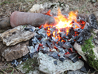 Experimental smelting place, furnace, crucible containing copper ore 